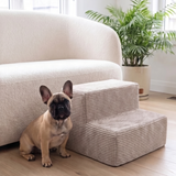 French bulldog sitting next to a Platinum PupStep 2-Step by a couch
