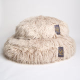 Large and small fluffy dog beds in beige flokati